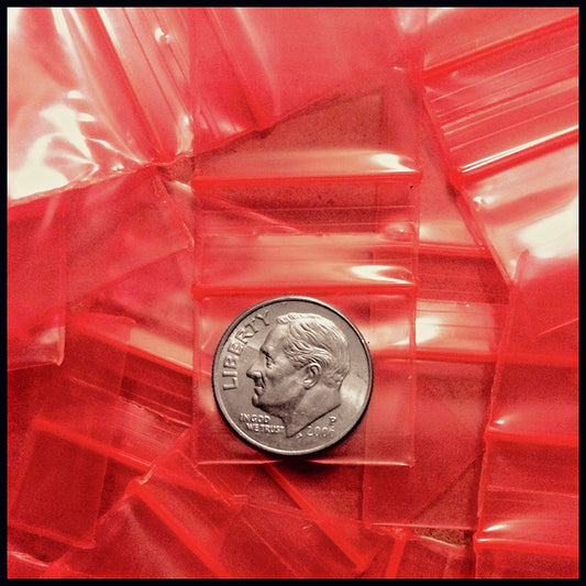 Red 5/8" x 5/8" Original Apple Bags with red twist ties, made of durable paper for packaging and gift wrapping.