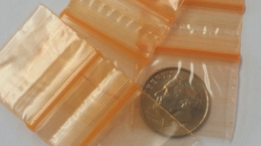 Orange Original Apple Bags measuring 5/8 inch by 5/8 inch, made from durable material, suitable for packaging small items.