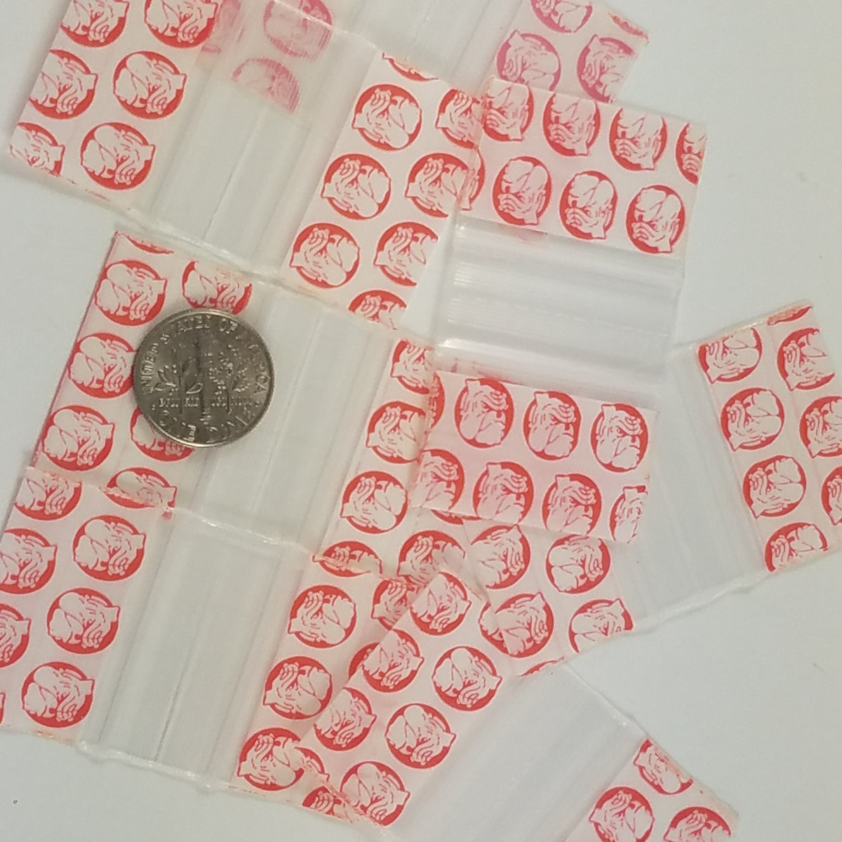 Red dog-themed resealable bags from Original Apple Bags, 1.25" x 3/4" size, ideal for packaging small items.