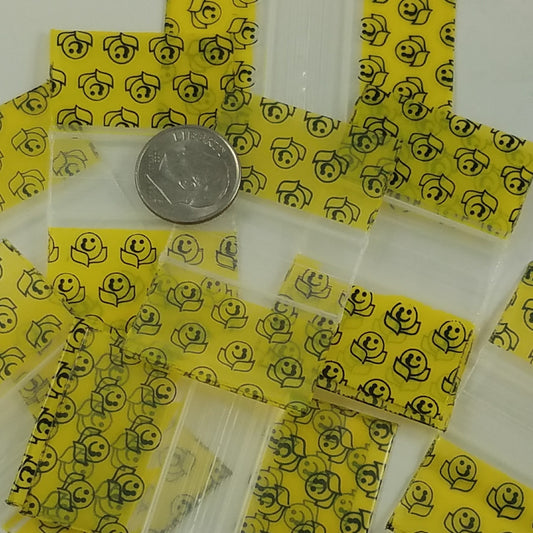 Original Apple Bags resealable bags with happy face design, measuring 1.25" x 3/4", perfect for storing small items.