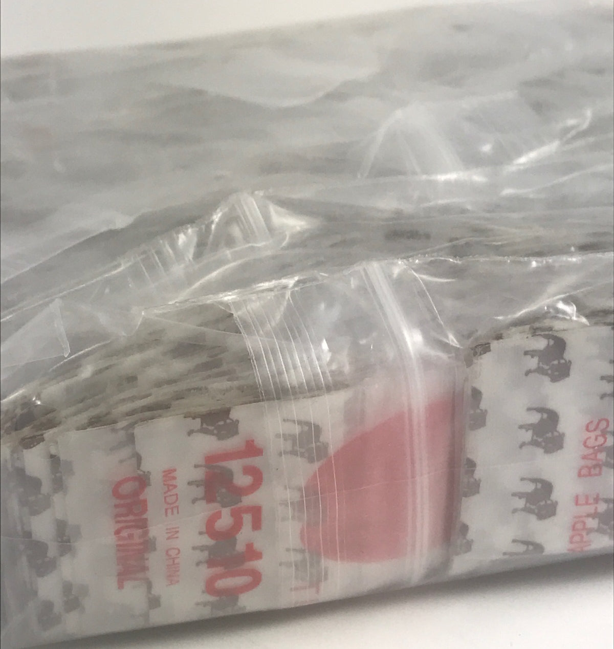 Resealable Original Apple Bags with top dog design, 1.25" x 1", ideal for packaging small items or treats.