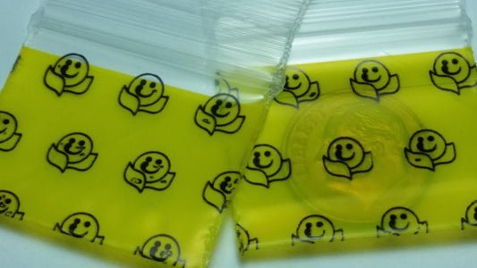 Original Apple Bags resealable bags with happy face design, 1.25" x 1" size, perfect for storing small items or treats.