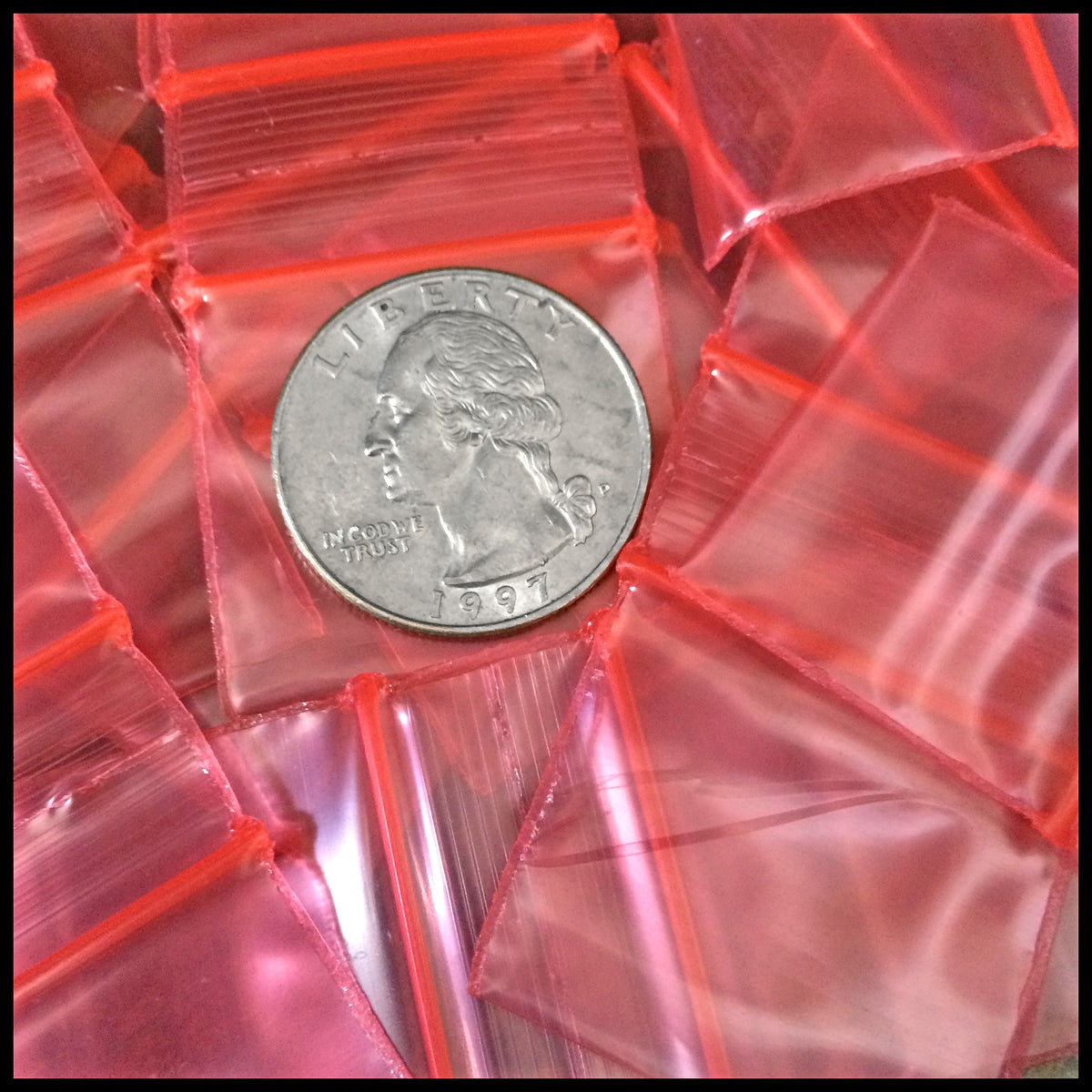 Red 1.25 x 1-inch resealable Apple Bags by Original Apple Bags, clear plastic storage pouches for small items.