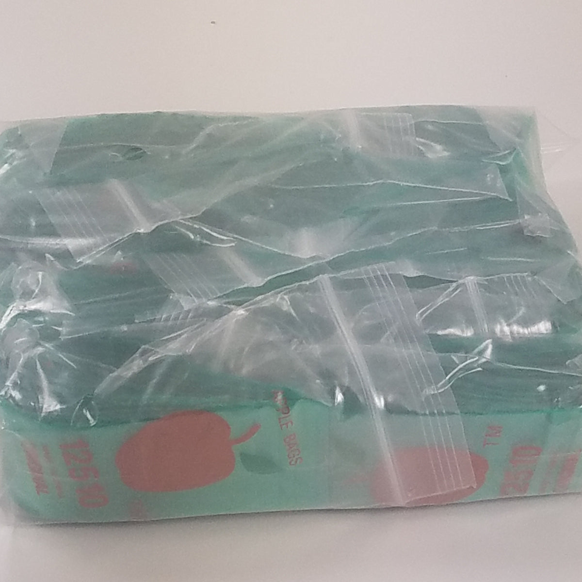 Green Original Apple Bags resealable bags, 1.25" x 1", ideal for storing small items or snacks.