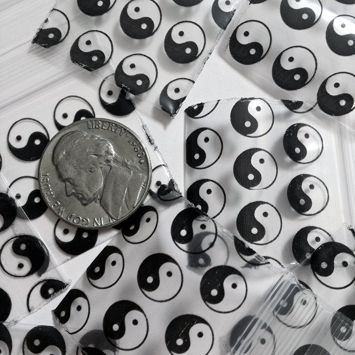 Original Apple Bags resealable bags featuring TaiJi/Yin Yang design, 1.25 x 1.25 inches, perfect for storage or packaging.