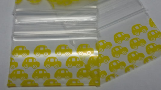 Original Apple Bags resealable taxi cab-themed bags, 1.5" x 1", with vibrant yellow and black taxi cab design.