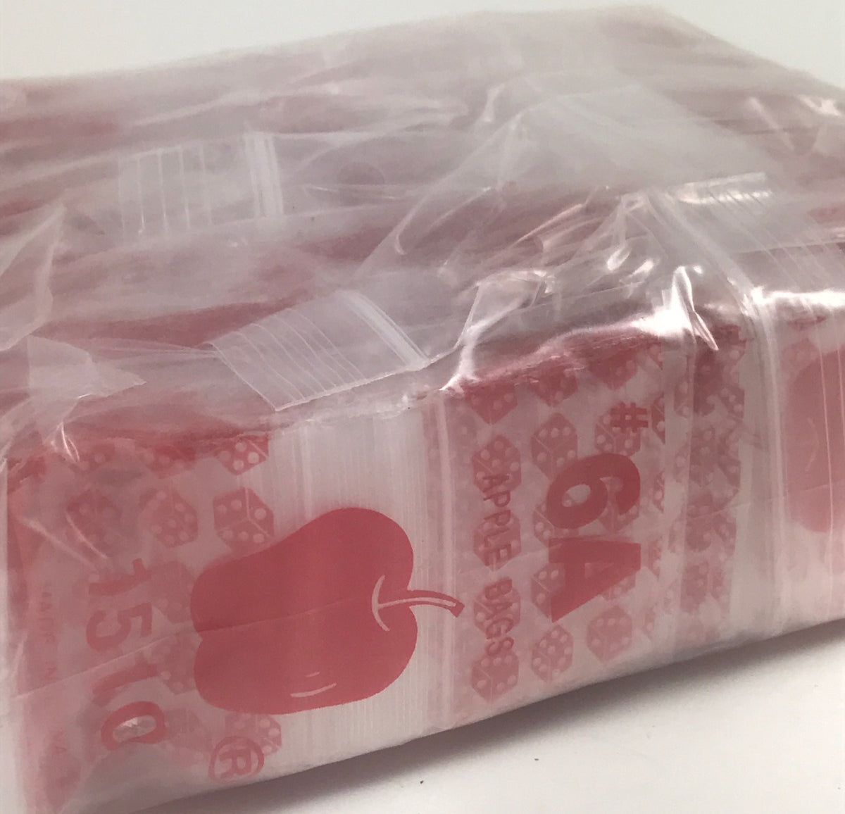 Red dice resealable bags from Original Apple Bags, 1.5" x 1", ideal for packaging small items or collectibles.