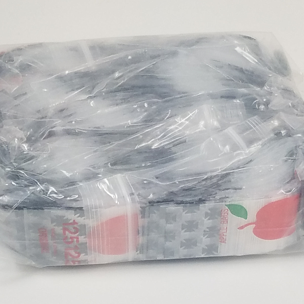 Original Apple Bags resealable bags, 1.25 x 1.25 inches, designed for storing small items or food, with clear, durable plastic material.