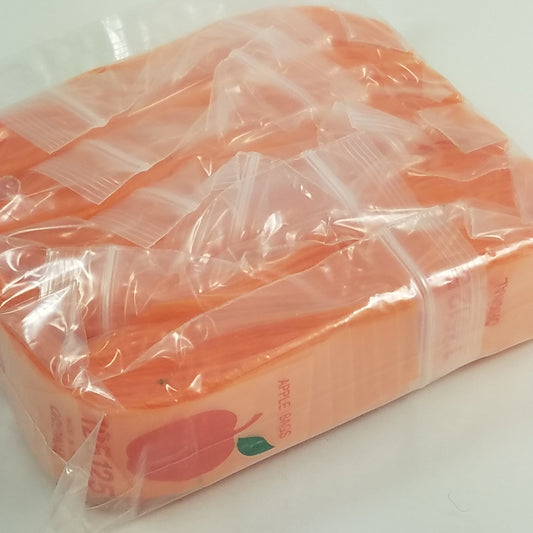 Original Apple Bags resealable bags in orange, 1.25 x 1.25 inches, with clear packaging showing the small, vibrant storage bags.