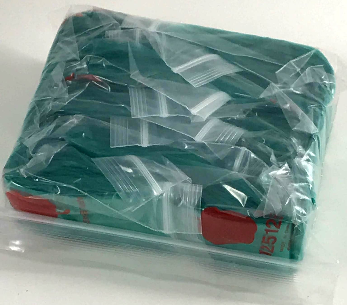 Green 1.25" x 1.25" resealable bags by Original Apple Bags, shown in a close-up image of the small, green plastic bags.