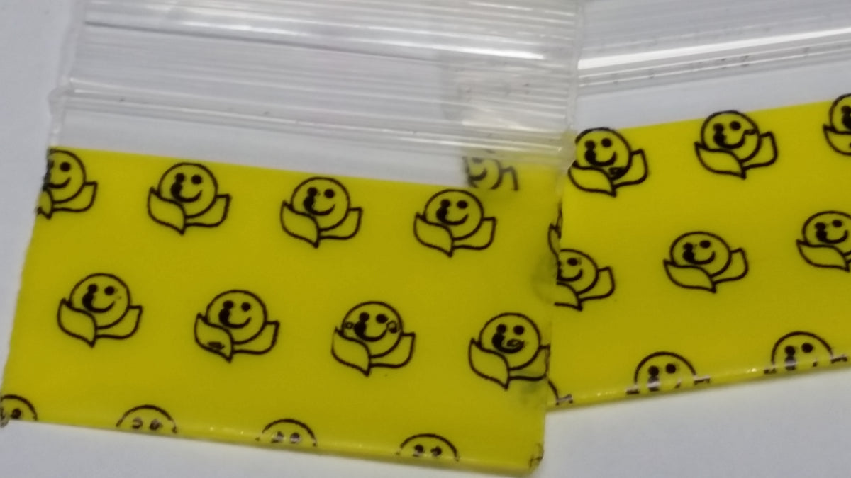 Resealable Original Apple Bags with happy face design, 1.5"x1", made for storing small items or treats.