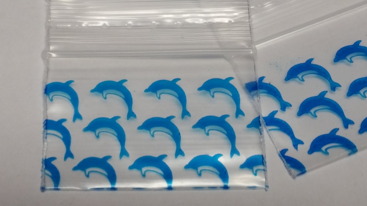 Blue dolphin resealable bags from Original Apple Bags, 1.5" x 1", ideal for storage and organization.