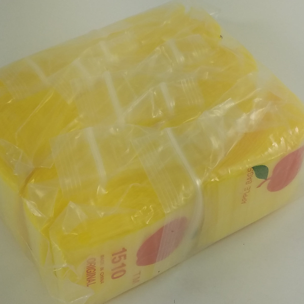Yellow 1.5 x 1-inch resealable Original Apple Bags for storing small items or snacks.