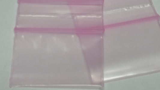 Pink 1.5 x 1-inch resealable Apple Bags by Original Apple Bags, showcasing the colorful, resealable plastic bags.