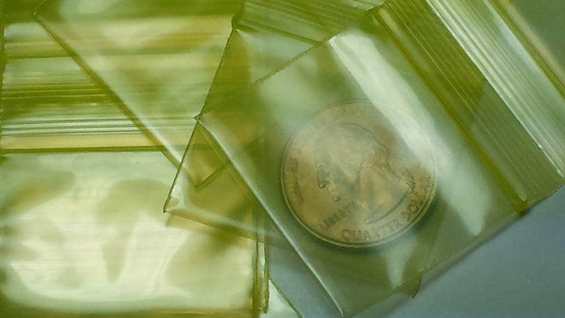 Yellow resealable bags from Original Apple Bags, 1.5 x 1.25 inches, ideal for storing small items or snacks.