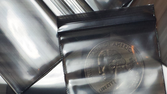 Black resealable bags from Original Apple Bags, measuring 1.5" x 1.25", ideal for secure storage and organization.