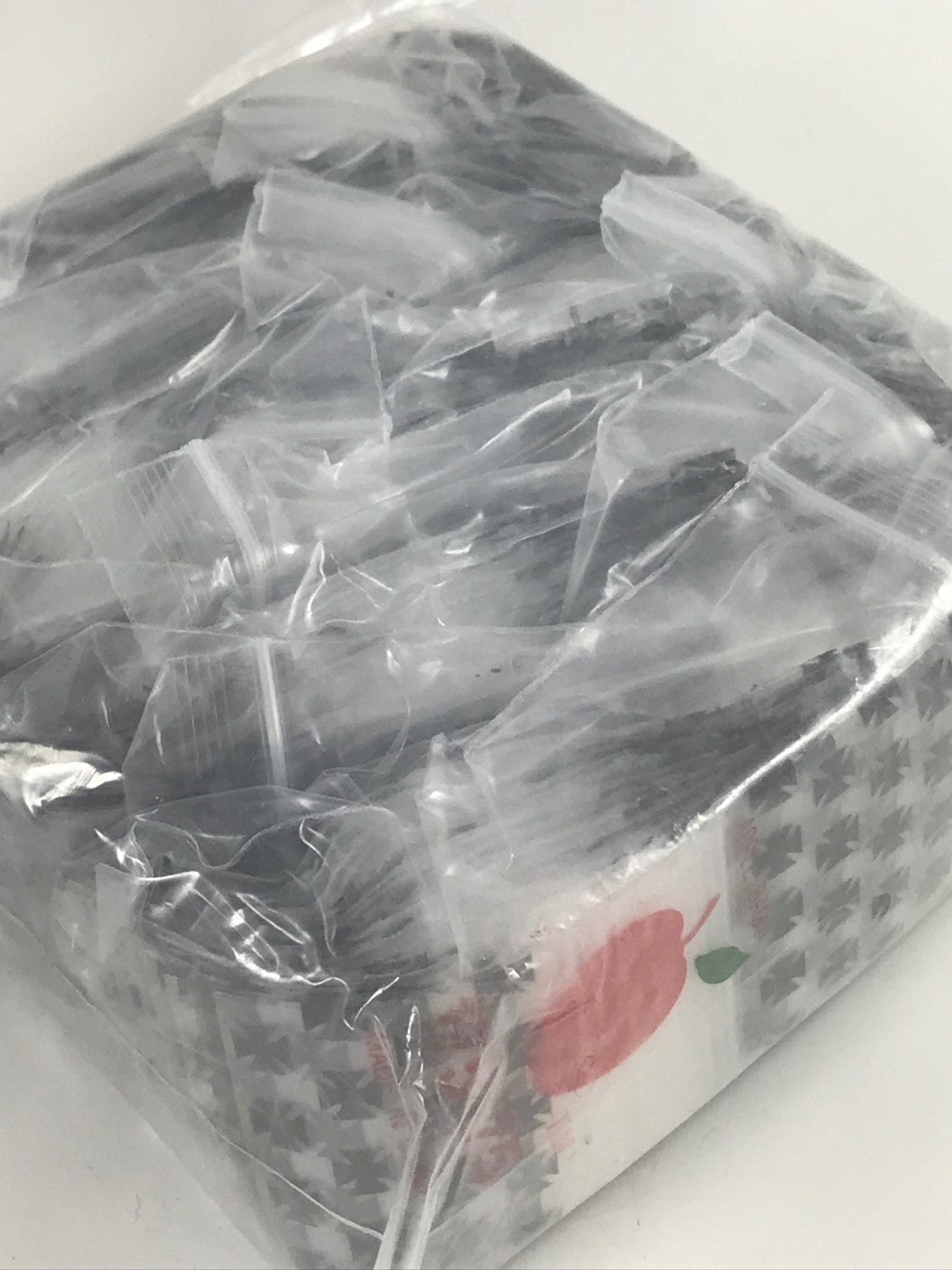 Original Apple Bags resealable bags, 1.75 x 1.75 inches, with clear material and green apple logo design.