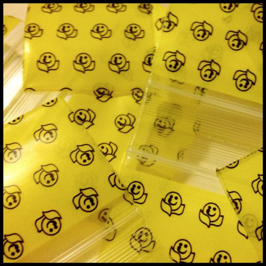 Resealable Original Apple Bags with happy face design, 1.5 x 1.5 inches, ideal for storing small items or snacks.