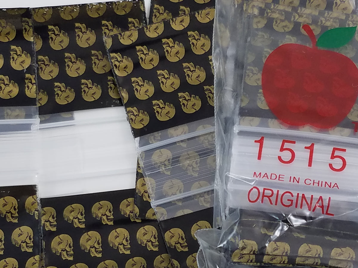 Resealable gold skulls on 1.5x1.5 inch Original Apple Bags, colorful packaging for small items or gifts.