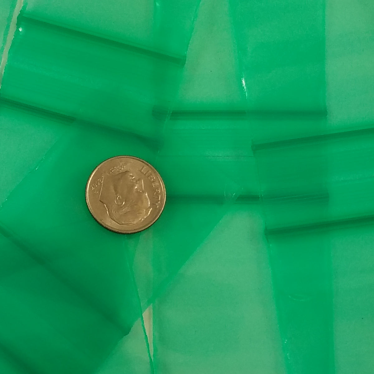 Green 1.5x1.5-inch resealable Apple Bags by Original Apple Bags, perfect for storage or packaging.