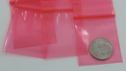 Red resealable Apple Bags by Original Apple Bags, measuring 1.5" x 1.75" for storing small items or produce.