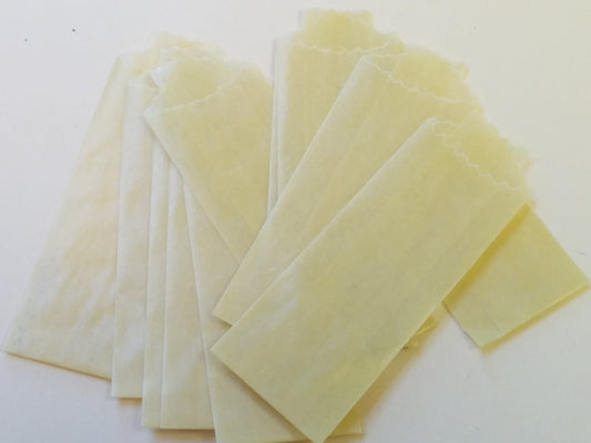 Yellow Vellum Glassine stamp wax paper envelope bags by Stamp Collectors Moisture Resistant Bags, ideal for protecting collectible stamps.