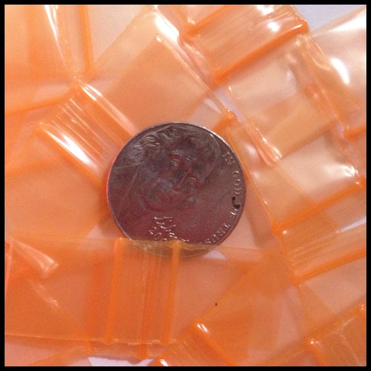 Resealable orange apple bags by Original Apple Bags, 5/8 inch by 5/8 inch, ideal for packaging small items.