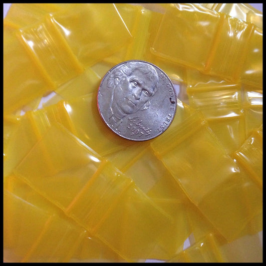 Yellow 5858 Original Apple Bags resealable bags, 5/8 inch by 5/8 inch, made by Original Apple Bags for storage and packaging.